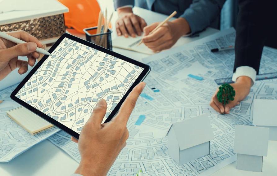 Worker, architect and engineer work on real estate construction project oratory planning with cartography and cadastral map of urban town area to guide to construction developer business plan of city